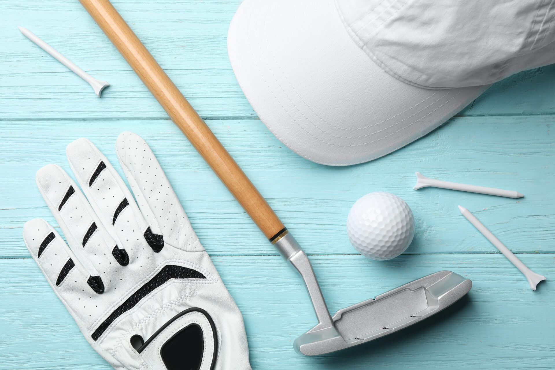 Flat lay composition with golf accessories on blue wooden background